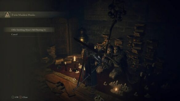 Black Twin Maiden Husks sitting around bronze items and bell bearings in Elden Ring.