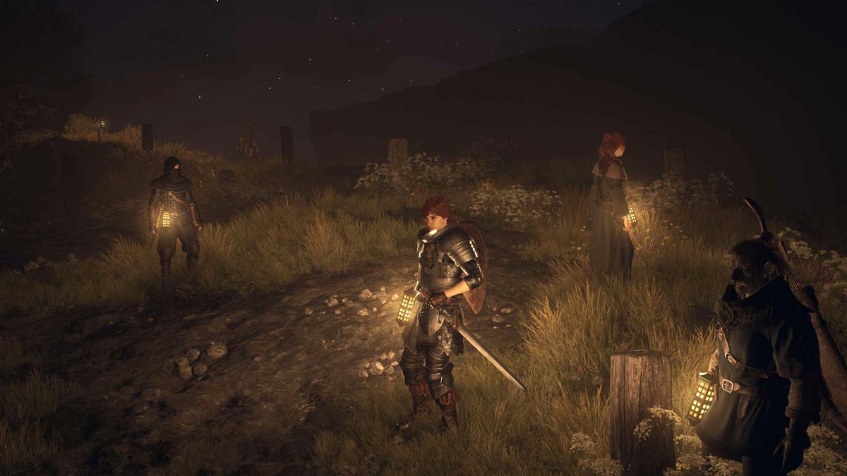 Personajes de Dragon's Dogma 2 sosteniendo linternas por la noche