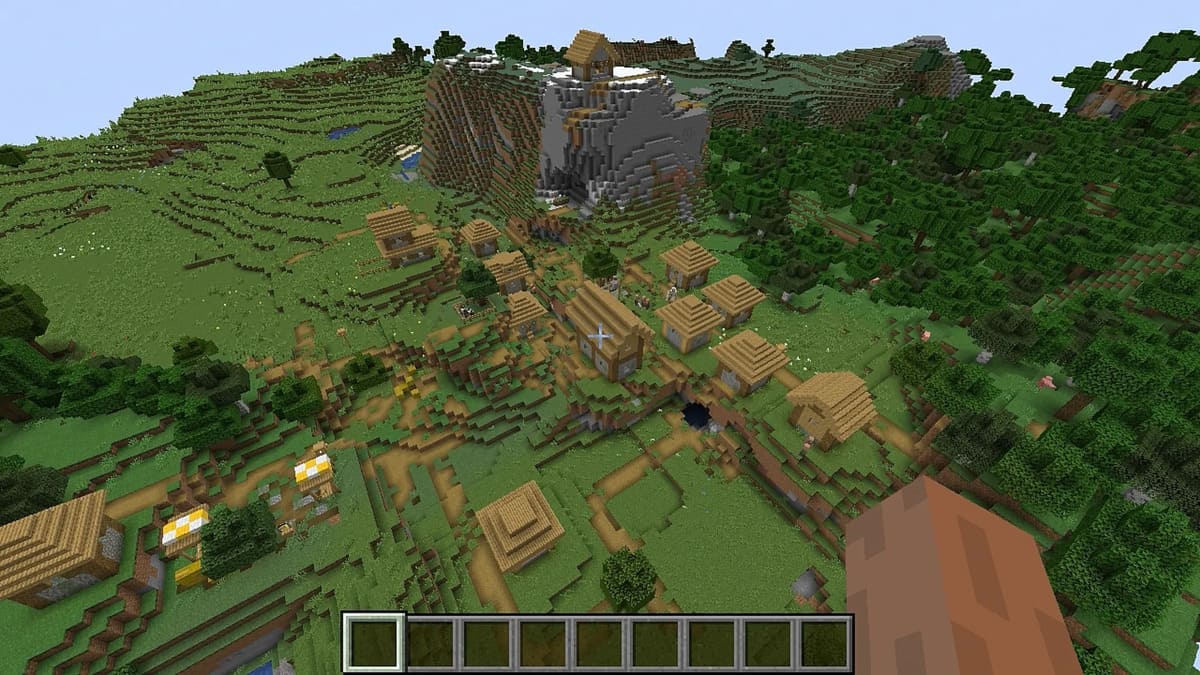 Colinas nevadas y pueblo en Minecraft